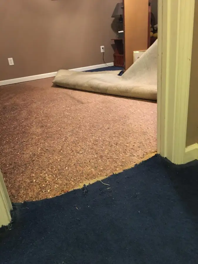 Carpet pad removal revealing water damage during Drying & Dehumidification in Brookhaven